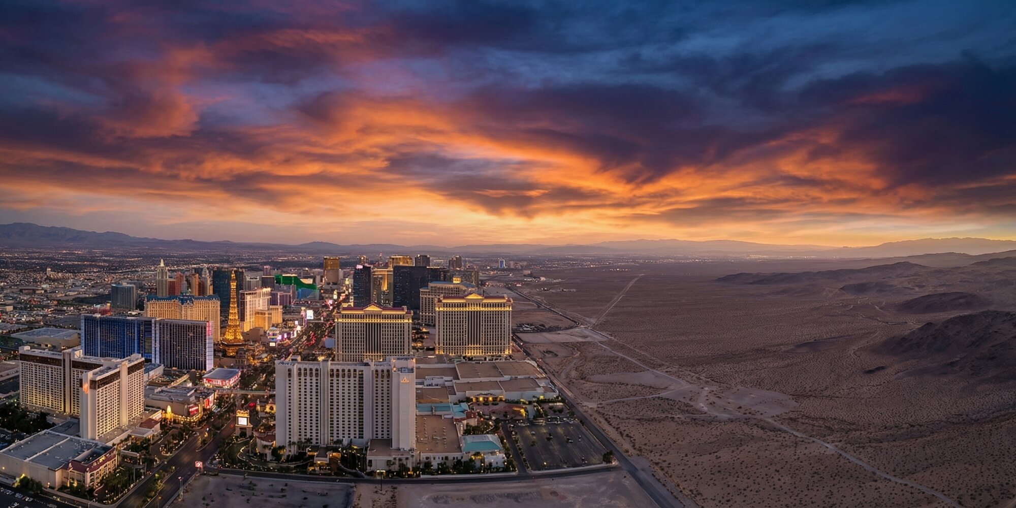 Aerial view of the Las Vegas Strip and surrounding desert landscape at dusk, illustrating Nevada's economic landscape