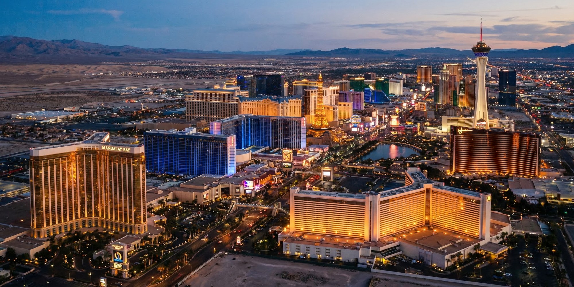 Cinematic aerial view of the Las Vegas Strip at dusk with the Mojave Desert horizon