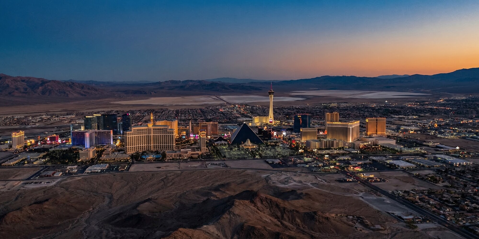 Aerial view of the Las Vegas Strip and surrounding Nevada desert at twilight, illustrating the state's concentrated economic landscape